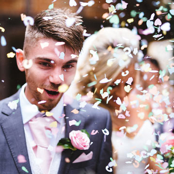 Bride and groom showered by confetti