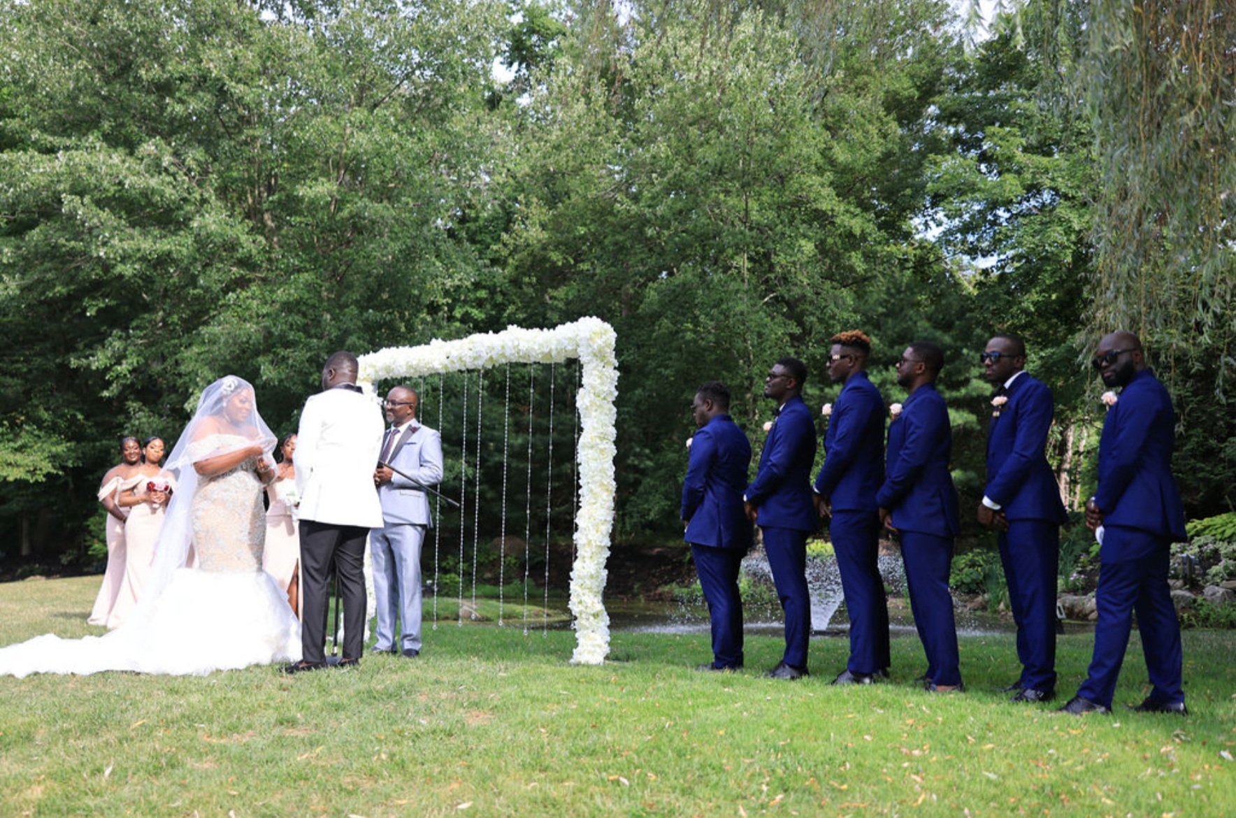 bride and groom standing near with reception gate and guest are waiting to pay tribute to them.