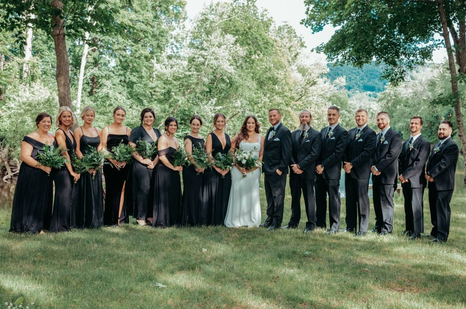 A group of people standing side by side to the bride in happy mode.