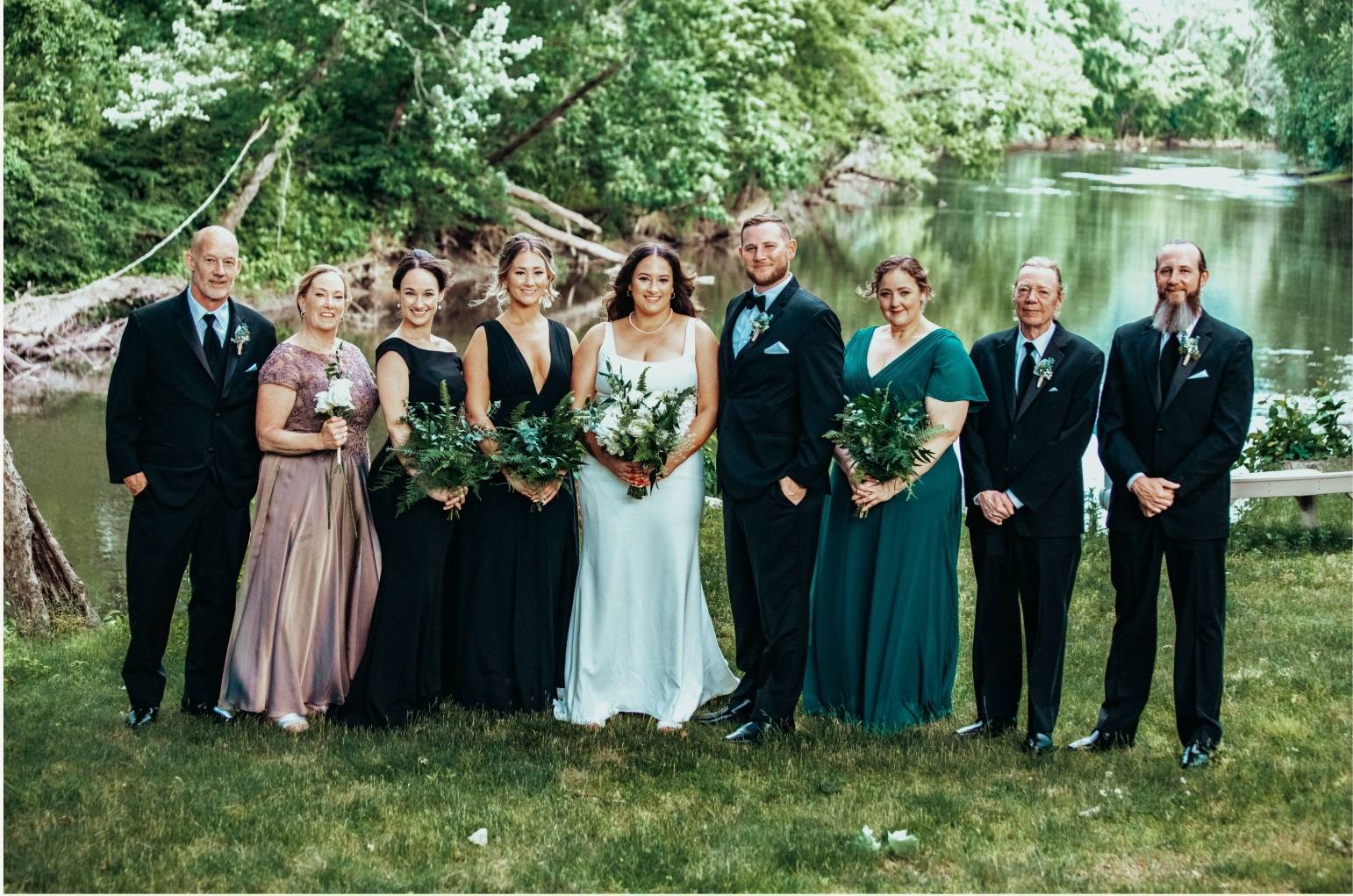 A group of man and women standing side by side to the bride.
