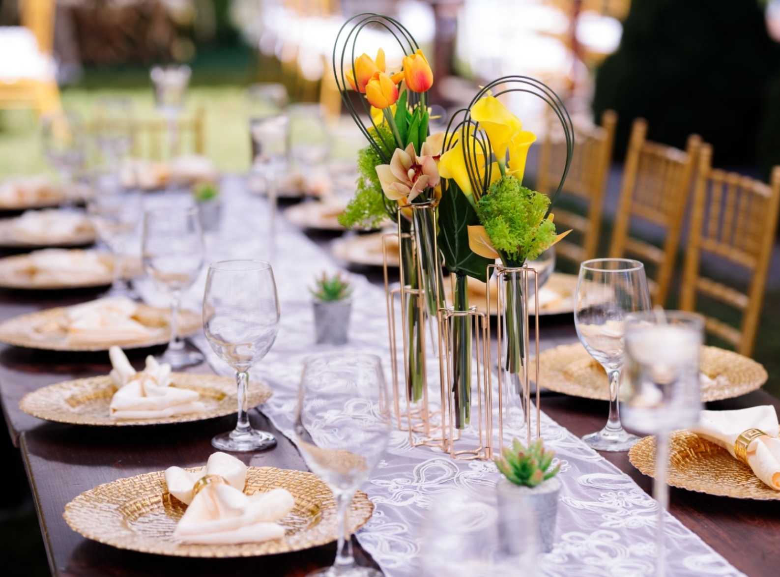 Elegant table set with plates, napkins and flower centerpieces